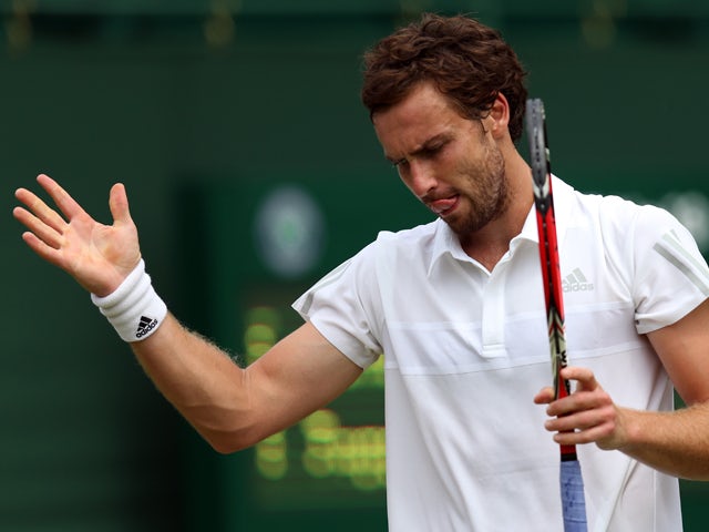 Ernests Gulbis reacts during his Gentlemen's Singles first round match against Jurgen Zopp of Estonia on day one of the Wimbledon Lawn Tennis Championships at the All England Lawn Tennis and Croquet Club at Wimbledon on June 23, 2014