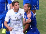 Giorgio Chiellini of Italy pulls down his shirt after a clash with Luis Suarez of Uruguay (not pictured) as Gaston Ramirez of Uruguay looks on June 24, 2014