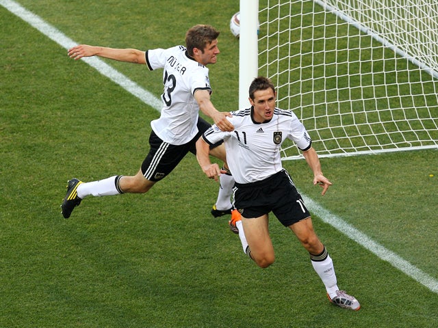 Miroslav Klose of Germany celebrates scoring the opening goal with team mate Thomas Muller during the 2010 FIFA World Cup South Africa Round of Sixteen match between Germany and England at Free State Stadium on June 27, 2010