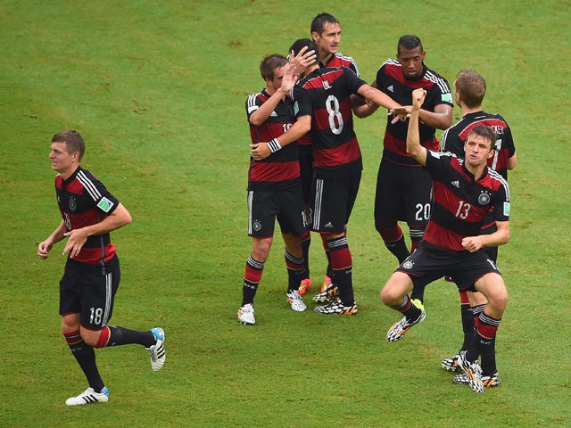 Thomas Muller of Germany celebrates scoring his team's first goal with teammates during the 2014 FIFA World Cup Brazil group G match between the United States and Germany at Arena Pernambuco on June 26, 2014
