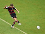 Thomas Mueller of Germany shoots and scores his team's first goal during the 2014 FIFA World Cup Brazil group G match between the United States and Germany at Arena Pernambuco on June 26, 2014