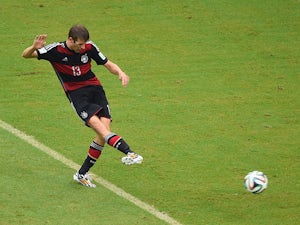 Thomas Mueller of Germany shoots and scores his team's first goal during the 2014 FIFA World Cup Brazil group G match between the United States and Germany at Arena Pernambuco on June 26, 2014