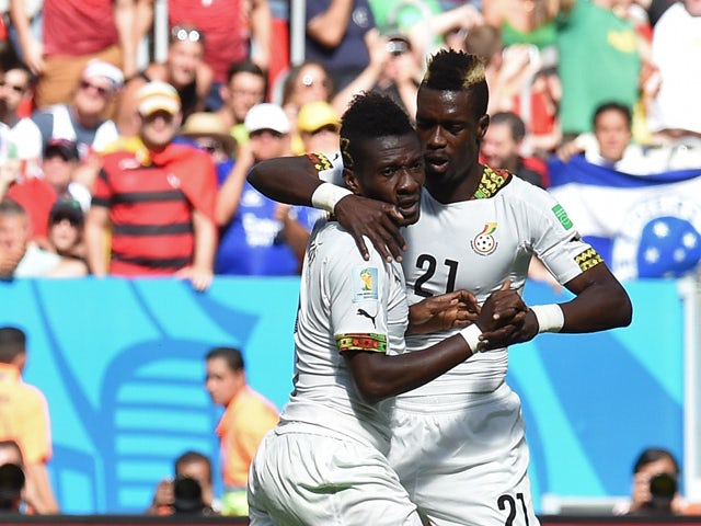 Ghana's forward and captain Asamoah Gyan celebrates with his temmate Ghana's defender John Boye after scoring a goal during the Group G football match between Portugal and Ghana at the Mane Garrincha National Stadium in Brasilia during the 2014 FIFA World