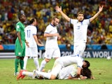 Giorgos Samaras of Greece celebrates with teammates after scoring his team's second goal on a penalty kick during the 2014 FIFA World Cup Brazil Group C match on June 24, 2014