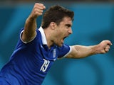 Greece's defender Sokratis Papastathopoulos celebrates after scoring during a Round of 16 football match between Costa Rica and Greece at Pernambuco Arena in Recife during the 2014 FIFA World Cup on June 29, 2014