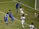 :Greece's defender Sokratis Papastathopoulos scores during a Round of 16 football match between Costa Rica and Greece at Pernambuco Arena in Recife during the 2014 FIFA World Cup on June 29, 2014