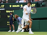 Grigor Dimitrov of Bulgaria plays a backhand shot during his Gentlemen's Singles second round match against Luke Saville of Australia on day three of the Wimbledon Lawn Tennis Championships at the All England Lawn Tennis and Croquet Club at Wimbledon on J