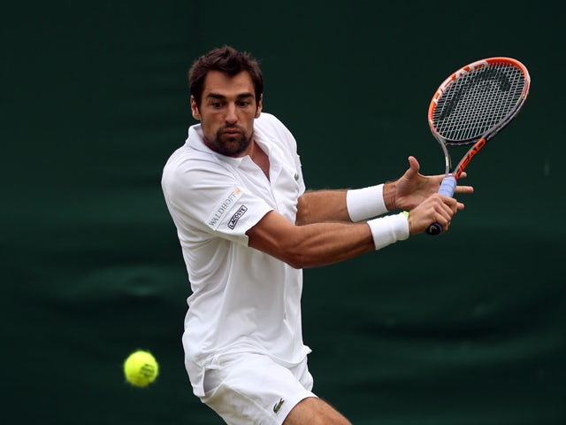 Jeremy Chardy of France plays a backhand during his Gentlemen's Singles first round match against Daniel Cox of Great Britain on day one of the Wimbledon Lawn Tennis Championships at the All England Lawn Tennis and Croquet Club at Wimbledon on June 23, 20
