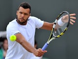 France's Jo-Wilfried Tsonga returns to Taiwan's Jimmy Wang during their men's singles third round match on day five of the 2014 Wimbledon Championships at The All England Tennis Club in Wimbledon, southwest London, on June 27, 2014