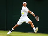 Kei Nishikori of Japan plays a backhand during his Gentlemen's Singles first round match against Kenny De Schepper of France on day two of the Wimbledon Lawn Tennis Championships at the All England Lawn Tennis and Croquet Club at Wimbledon on June 24, 201
