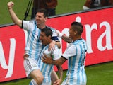 Lionel Messi celebrates with Argentina teammates Angel Di Maria and Marcos Rojo after opening the scoring against Nigeria in their World Cup Group F match on June 25, 2014