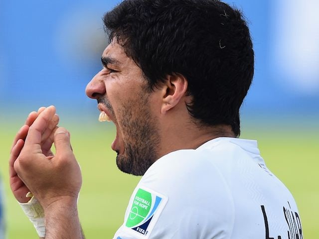 A close-up of Luis Suarez holding his gnashers on June 24, 2014.