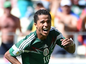 Mexico's forward Giovani Dos Santos celebrates after scoring during a Round of 16 football match between Netherlands and Mexico at Castelao Stadium in Fortaleza during the 2014 FIFA World Cup on June 29, 2014