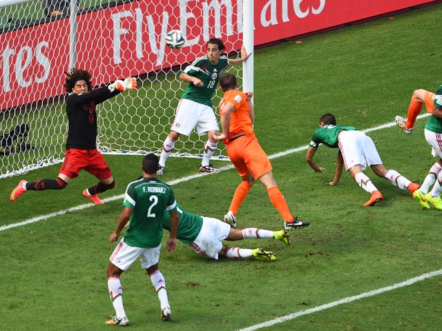 Goalkeeper Guillermo Ochoa of Mexico makes a save after a shot at goal by Stefan de Vrij of the Netherlands during the 2014 FIFA World Cup Brazil Round of 16 match between Netherlands and Mexico at Castelao on June 29, 2014