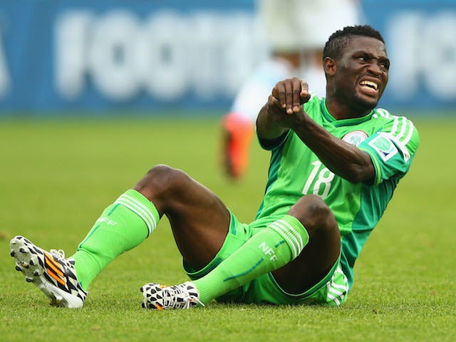 Michael Babatunde of Nigeria reacts after a possible injury during the 2014 FIFA World Cup Brazil Group F match against Argentina on June 25, 2014