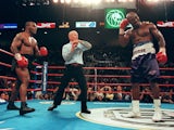 Referee Lane Mills stops the fight in the third round as Evander Holyfield holds his ear as Mike Tyson watches 28 June, 1997