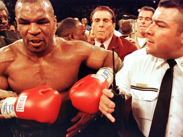 Mike Tyson is held back by police after his fight against Evander Holyfield 28 June, 1997