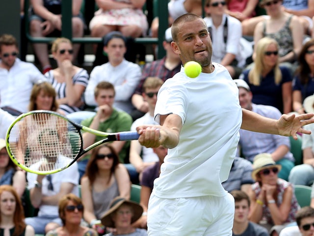 Mikhail Youzhny of Russia plays a forehand during his Gentlemen's Singles first round match against James Ward of Great Britain on day one of the Wimbledon Lawn Tennis Championships at the All England Lawn Tennis and Croquet Club at Wimbledon on June 23, 