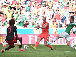Netherlands' forward Arjen Robben vies for the ball with Mexico's defender Miguel Layun and Mexico's goalkeeper Guillermo Ochoa during a Round of 16 football match between Netherlands and Mexico at Castelao Stadium in Fortaleza during the 2014 FIFA World 