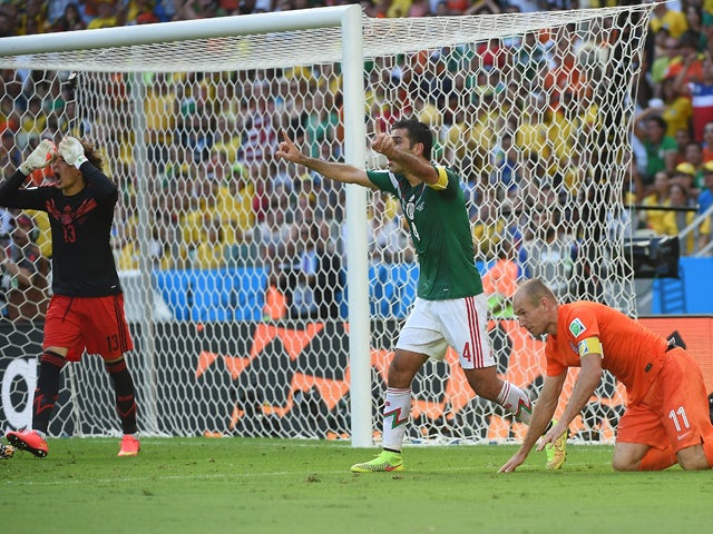 Mexico's defender and captain Rafael Marquez and Mexico's goalkeeper Guillermo Ochoa react after the awarding of a penalty after a tackle on Netherlands' forward Arjen Robben during a Round of 16 football match between Netherlands and Mexico at Castelao S
