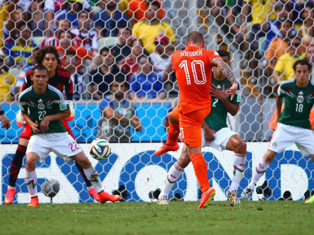 Wesley Sneijder of the Netherlands shoots and scores his team's first goal past Guillermo Ochoa of Mexico during the 2014 FIFA World Cup Brazil Round of 16 match between Netherlands and Mexico at Castelao on June 29, 2014