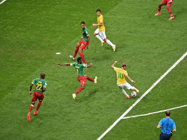 Brazil's forward Neymar (C) strikes the ball to score a second goal during the Group A football match against Cameroon on June 23, 2014