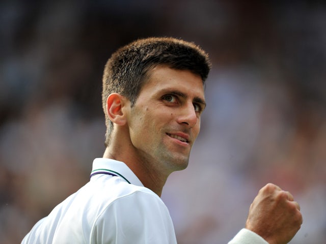 Serbia's Novak Djokovic reacts after scoring a point against Kazakhstan's Andrey Golubev during their men's singles first round match on day one of the 2014 Wimbledon Championships at The All England Tennis Club in Wimbledon, southwest London, on June 23,