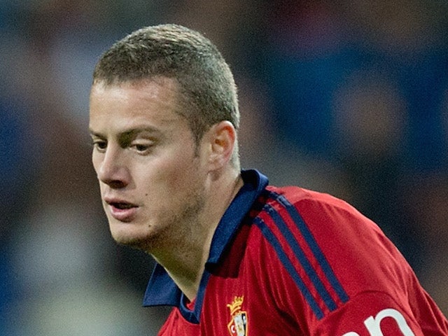 Oriol Riera of CA Osasuna strikes the ball during the Copa del Rey Round of 8 first match between Real Madrid and CA Osasuna at Estadio Santiago Bernabeu on January 9, 2014