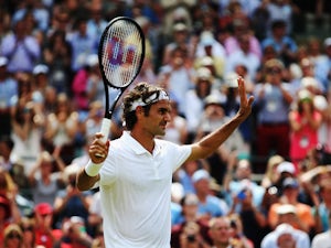 Roger Federer of Switzerland celebrates after defeating his Gentlemen's Singles first round match against Paolo Lorenzi of Italy on day two of the Wimbledon Lawn Tennis Championships at the All England Lawn Tennis and Croquet Club at Wimbledon on June 24,