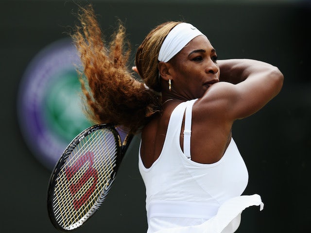 Serena Williams of the United States hits a forehand return during her Ladies' Singles third round match against Alize Cornet on June 28, 2014
