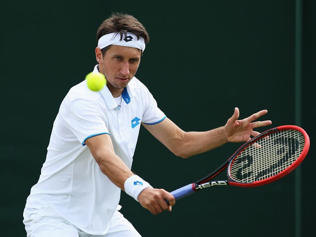 Sergiy Stakhovsky of Ukraine returns the ball during his Gentlemen's Singles second round match against Ernests Gulbis of Latvia on day three of the Wimbledon Lawn Tennis Championships at the All England Lawn Tennis and Croquet Club at Wimbledon on June 2