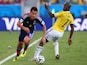 Shinji Okazaki of Japan driblbles past Pablo Armero of Colombia during the 2014 FIFA World Cup Brazil Group C match between Japan and Colombia at Arena Pantanal on June 24, 2014