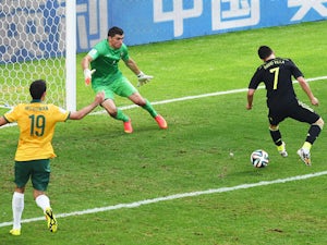 David Villa of Spain scores his team's first goal with a back heel past Mathew Ryan of Australia during the 2014 FIFA World Cup Brazil Group B match between Australia and Spain at Arena da Baixada on June 23, 2014 