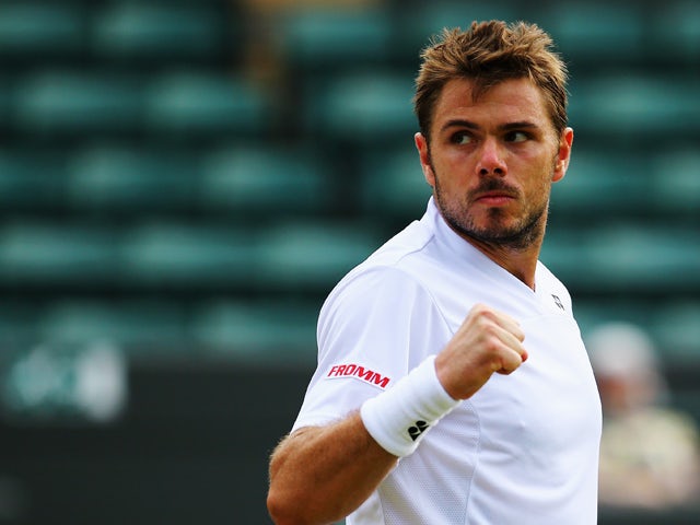 Stanislas Wawrinka of Switzerland celebrates during his Gentlemen's Singles second round match against Yen-Hsun Lu of Chinese Taipei on day four of the Wimbledon Lawn Tennis Championships at the All England Lawn Tennis and Croquet Club at Wimbledon on Jun