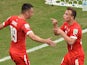 Switzerland's midfielder Xherdan Shaqiri celebrates with forward Josip Drmic (L) after scoring his team's second goal during the Group E football match between Honduras and Switzerland at the Amazonia Arena in Manaus during the 2014 FIFA World Cup on June