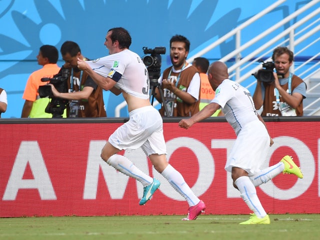 Uruguay's defender Diego Godin celebrates scoring with his teammates during the Group D football match between Italy and Uruguay at the Dunas Arena in Natal during the 2014 FIFA World Cup on June 24, 2014