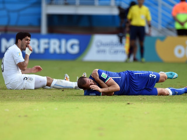 Uruguay's forward Luis Suarez reacts past Italy's defender Giorgio Chiellini during a Group D football match between Italy and Uruguay at the Dunas Arena in Natal during the 2014 FIFA World Cup on June 24, 2014