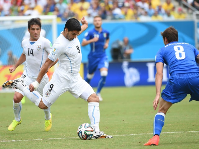 Uruguay's forward Luis Suarez and Italy's midfielder Claudio Marchisio vie during the Group D football match between Italy and Uruguay at the Dunas Arena in Natal during the 2014 FIFA World Cup on June 24, 2014