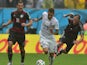 Germany's forward Lukas Podolski and Germany's defender Benedikt Howedes vie for the ball with US defender Fabian Johnson during a Group G football match between US and Germany at the Pernambuco Arena in Recife during the 2014 FIFA World Cup on June 26, 2