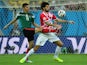 Croatia's defender Vedran Corluka (R) and Mexico's forward Oribe Peralta vie for the ball during a Group A football match on June 23, 2014