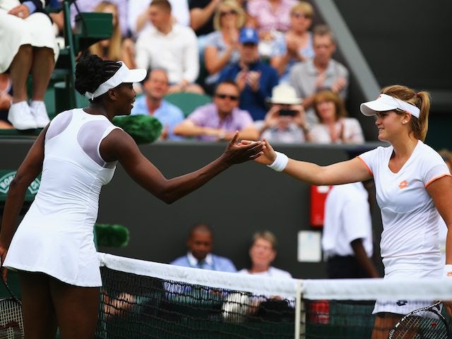 Venus Williams and Maria-Teresa Torro-Flor shake hands after their first-round Wimbledon encounter on June 23, 2014.