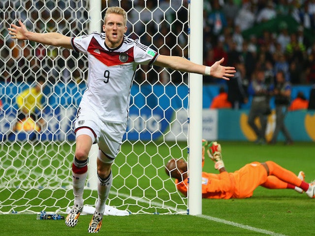 Andre Schuerrle of Germany celebrates scoring his team's first goal past goalkeeper Rais M'Bolhi of Algeria during the 2014 FIFA World Cup on June 30, 2014