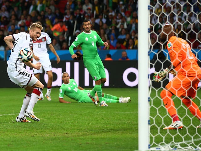 Andre Schuerrle of Germany scores his team's first goal past goalkeeper Rais M'Bolhi of Algeria in extra time during the 2014 FIFA World Cup on June 30, 2014