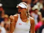 Angelique Kerber of Germany celebrates during her Ladies' Singles fourth round match against Maria Sharapova of Russia on day eight of the Wimbledon Lawn Tennis Championships at the All England Lawn Tennis and Croquet Club on July 1, 2014