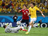 Julio Cesar of Brazil challenges Carlos Bacca of Colombia resulting in a penalty kick and yellow card for Cesar as David Luiz defends during the 2014 FIFA World Cup Brazil Quarter Final match between Brazil and Colombia at Castelao on July 4, 2014