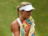 Eugenie Bouchard of Canada stands dejected during the Ladies' Singles final match against Petra Kvitova on July 5, 2014