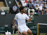 Spain's Feliciano Lopez winning a game against US player John Isner during his men's singles third round match on day seven of the 2014 Wimbledon Championships at The All England Tennis Club in Wimbledon, southwest London, on June 30, 2014