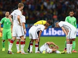 Shkodran Mustafi of Germany lies on the field as his teammates and referee Sandro Ricci look on during the 2014 FIFA World Cup Brazil Round of 16 match between Germany and Algeria at Estadio Beira-Rio on June 30, 2014