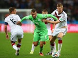 Islam Slimani of Algeria is challenged by Philipp Lahm (L) and Per Mertesacker of Germany during the 2014 FIFA World Cup on June 30, 2014