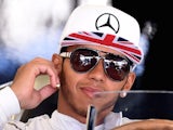 Mercedes driver Lewis Hamilton sits in the pits during the first practice session of the British Grand Prix at the Silverstone circuit on July 4, 2014